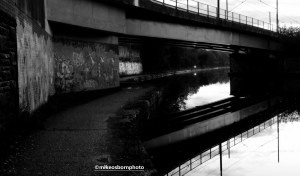 Cyclist approaches along Bridgewater Canal towpath, Manchester