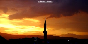 Minaret set against stormy sunset in Prizren, Kosovo