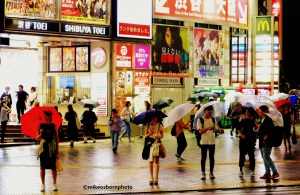Pedestrians in Shibuya, Tokyo, Japan holding umbrellas in the rain