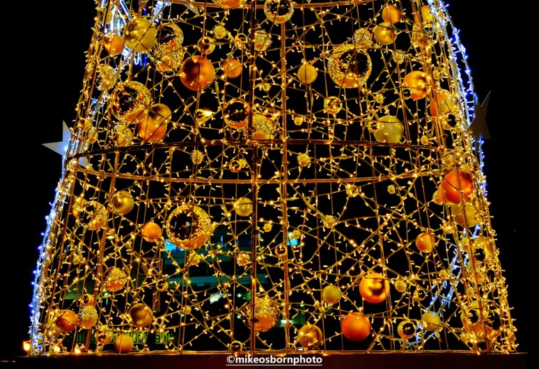 Christmas tree lit up at night in Manchester city centre.