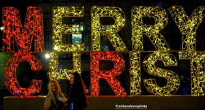 Women pose for photos at Christmas lights in Manchester