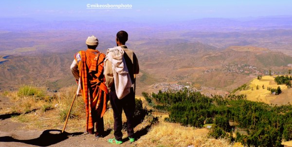Two Ethiopian men take in the view over countryside near Lalibela