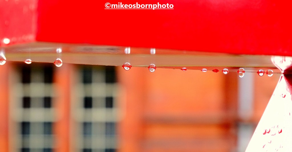 Raindrops on red sculpture outside Manchester's Whitworth Gallery