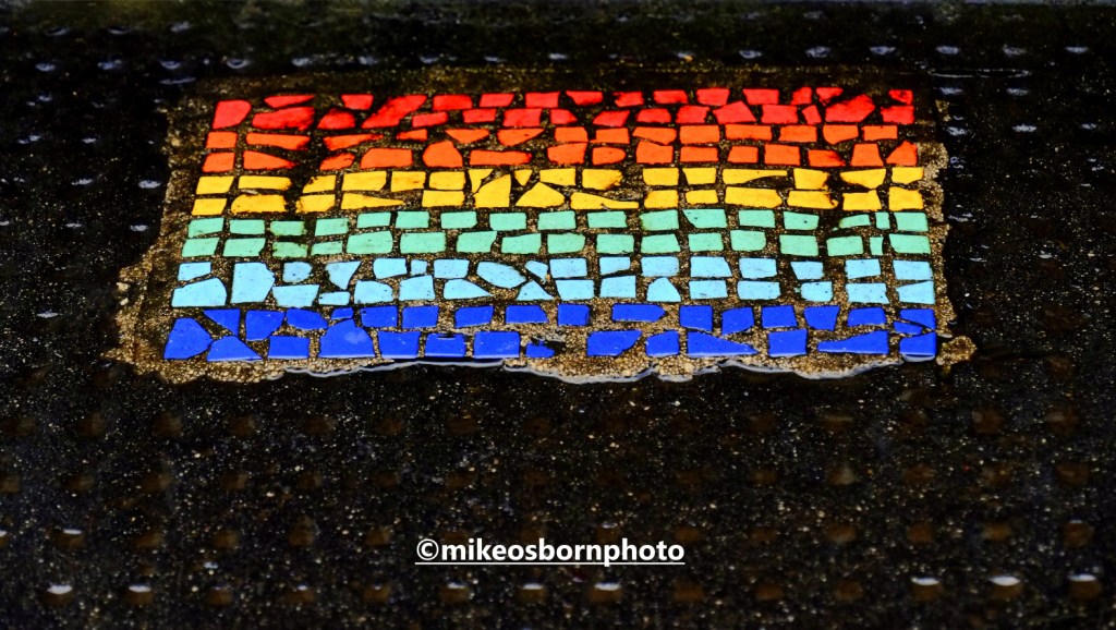 Rainbow pavement mosaic in Manchester