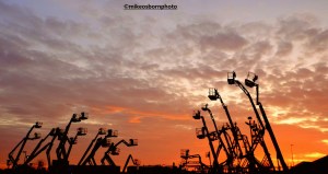 Cherry pickers at sunset in Salford