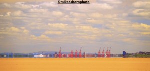 The cranes of the Mersey estuary seen from Hoylake beach, Wirral