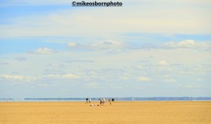 Beachgoers on the vast sands of Hoylake beach, Wirral