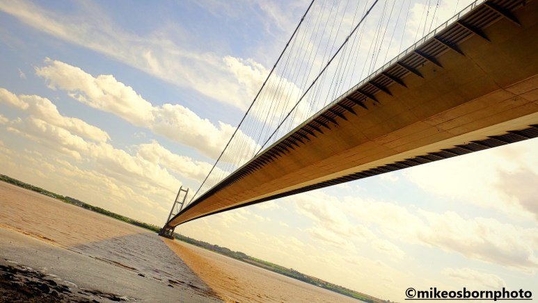 Angled view of the Humber Bridge from the shores of the river