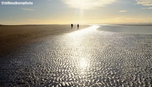 Two walkers on a sunny winter's day on Formby Beach, Merseyside