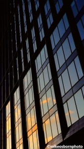 Sunset in glass facade of Vita Living complex, Oxford Road, Manchester