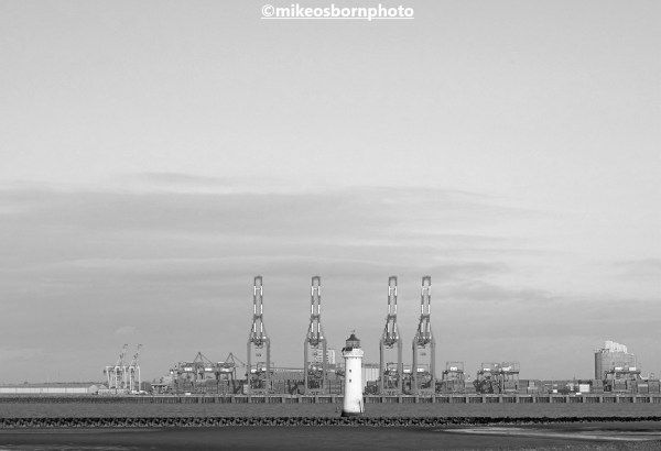 New Brighton lighthouse and red cranes of Liverpool port