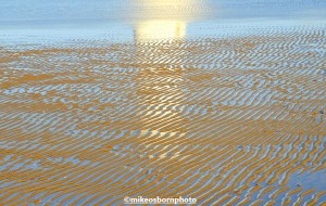 Reflection of New Brighton lighthouse in the sand