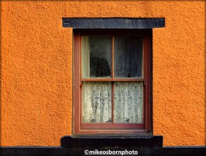 An old window and ochre walls of a property in Clitheroe, Lancashire