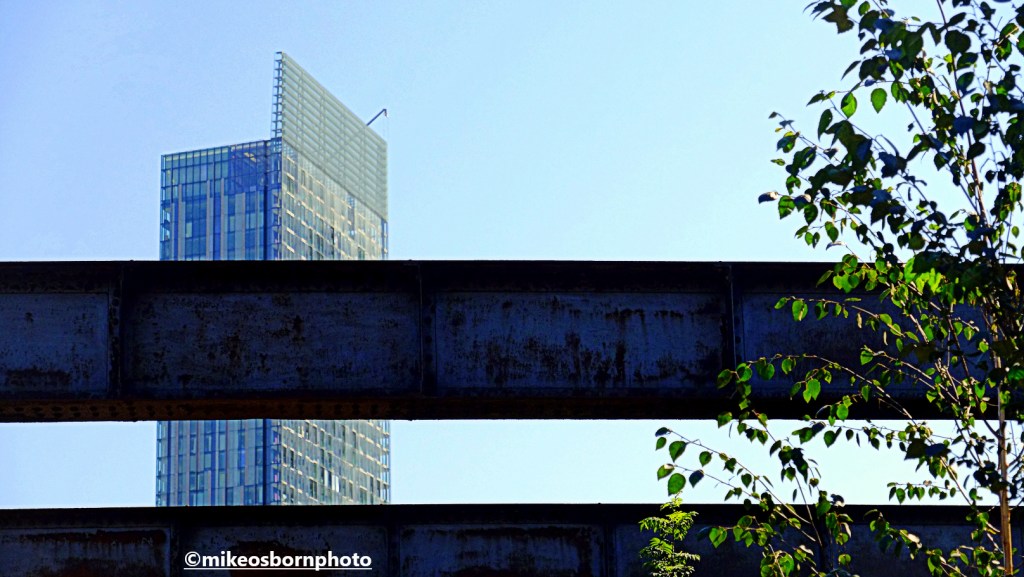 Manchester's Beetham Tower obscured by the metal struts of Castlefield Viaduct