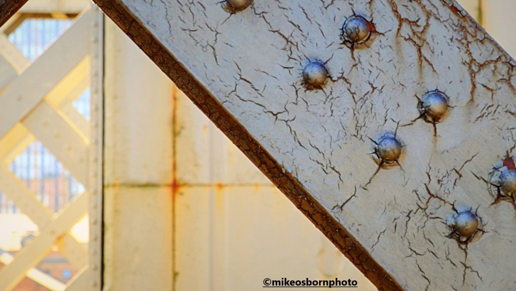 The cracked and rusted metal of Castlefield Viaduct