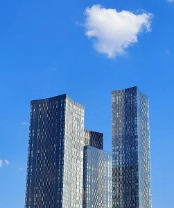 Manchester's Deansgate Square under a summer sky