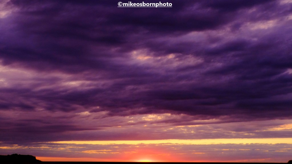A rich, deep purple-tinged sunset seen from Cromer pier, Norfolk, UK