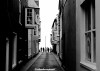 A black and white image of visitors at the end of a street in Cromer, Norfolk