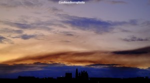 A plume of dark smoke haunts a sunrise view of Whitby Abbey in North Yorkshire