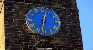 The blue clock face of the parish church at Howarth in Yorkshire