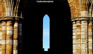 An archway and slender window of Whitby's ruined abbey