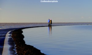 A couple walks on the path around West Kirby's Marine Lake