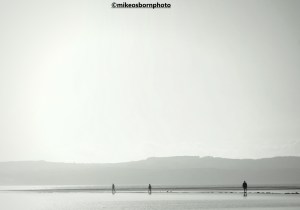 A sunny winter view of walkers around West Kirby's Marine Lake on the Wirral, UK