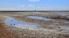 The expanse of reflections on Southport Beach at low tide