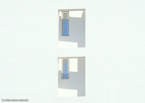 A sun-splashed modern whitewashed building on the coast of Tinos island, Greece