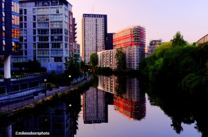 Apartment blocks along Manchester's River Irwell reflected perfectly