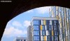 Brightly coloured apartment blocks see through a Victorian railway tunnel in Castlefield, Manchester