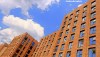 The open windows of a canalside apartment block in Manchester on a bright summer's day