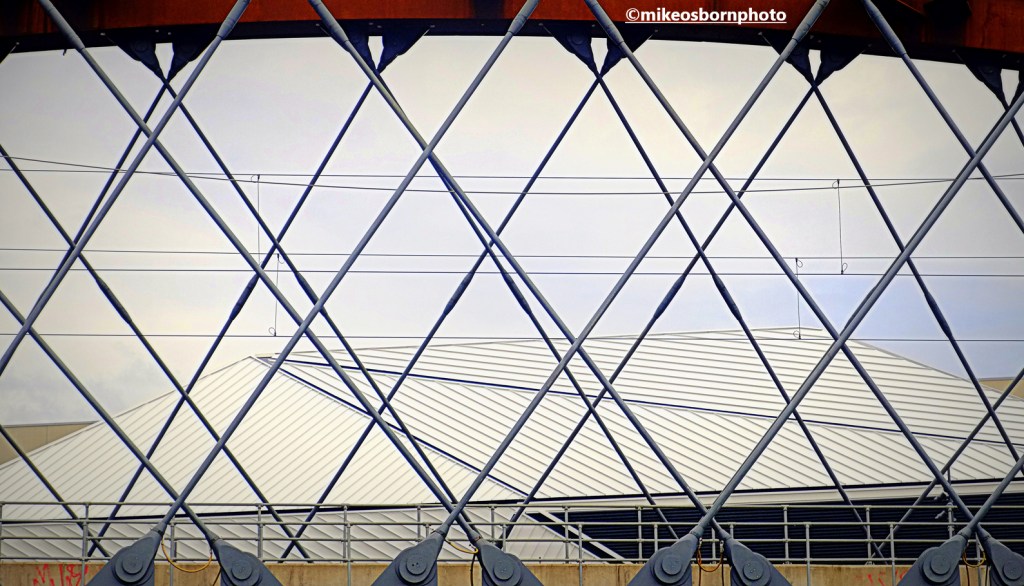 The Aviva Studios site seen through the struts of the Ordsall Chord railway bridge in Manchester