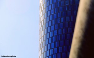 The round tower of Crown Street Manchester captured against a blue summer sky