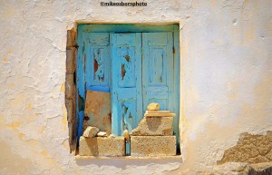 A tumbledown window on a house in Serifos, Greek islands