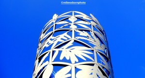 A blue and white monument against a clear blue sky in Wellington, New Zealand.
