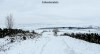 Two walkers on a snow-bound path in the hills of the Peak District.