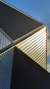 Manchester's Aviva Studios reflecting the sun on a winter's day.