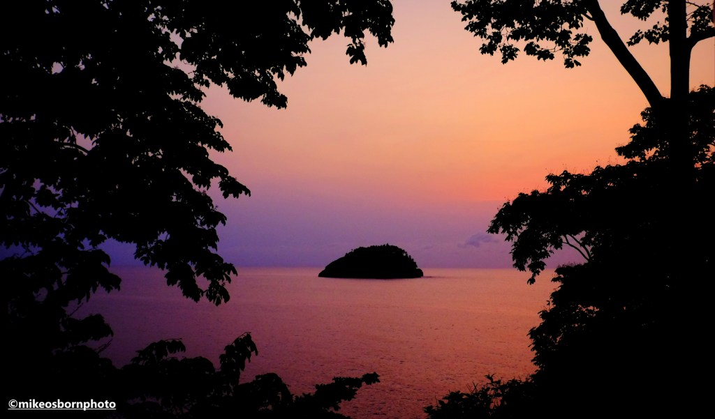 A pink-hued sunrise capturing Santana islet in São Tomé.
