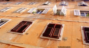 An old facade of shuttered windows in the Montenegrin city of Kotor.