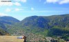 Teenage girls sunbathe on a ledge overlooking the city of Kotor, Montenegro.