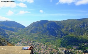 Teenage girls sunbathe on a ledge overlooking the city of Kotor, Montenegro.