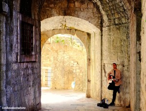 A street musician plays in one of the old tunnels of Kotor in Montenegro.