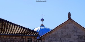 Old rooftops and the light blue church dome of Our Lady of the Rocks island near Perast, Montenegro.
