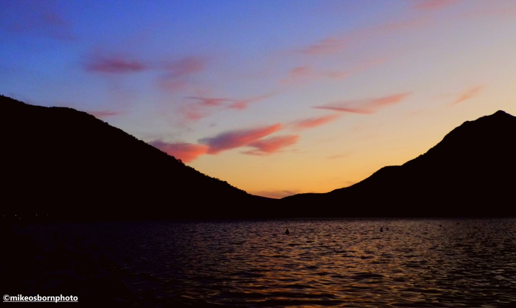 A beautiful sunset behind the hills of the Bay of Kotor in Montenegro, as seen from the town of Perast.