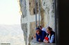 Visitors to Ostrog Monastery in Montenegro stand and gaze in contemplation.