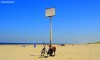 A bicycle rests against a sign post for the nudist beach at Hoek Van Holland Strand in the Netherlands.