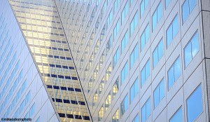 The light blue reflective glass of a modern building in Rotterdam city centre in the Netherlands.
