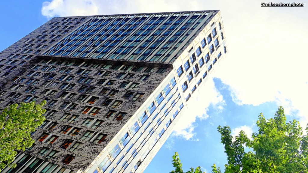A residential tower block in central Rotterdam covered in a brush-stroked design.