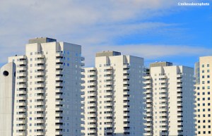 A trio of white apartment blocks by the river in Rotterdam, the Netherlands.